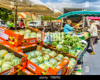 Artichokes and melons for sale on market day in Les Hérolles, Vienne, France. Stock Photo