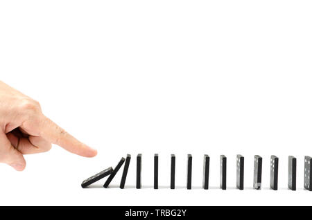 Finger, human hand drops the bones of dominoes on a white background. Stock Photo