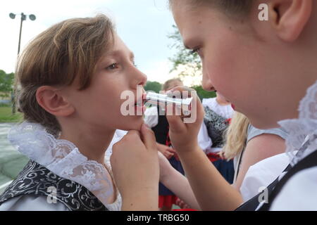 Young women, in traditional folk dresses, prepare for performance Stock Photo