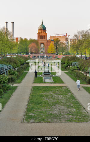 BERLIN, GERMANY - APRIL 18, 2019: People walk in a park in front of Engelbecken or Angel pond and St. Michael's Church at spring. Berlin is the capita Stock Photo