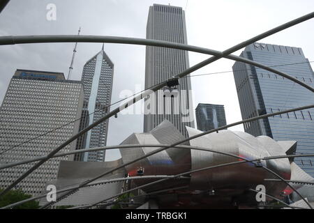 Chicago's Millennium Park with Jay Pritzker Pavilion, a bandshell designed by Frank Gehry. The pavilion has 4,000 fixed seats. Stock Photo