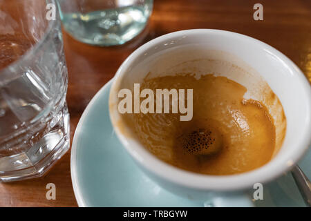 Empty cup of coffee on a wooden table at the bar Stock Photo
