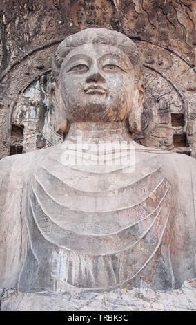 A weathered and ancient Buddha statue and carvings longmen grottoes in Luoyang China in Henan Province. Stock Photo