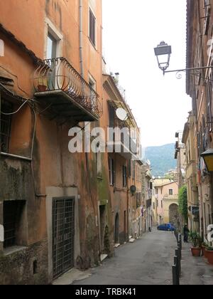 A typical narrow Italian street with tall buildings on either side; town of Tivoli, Lazio Stock Photo