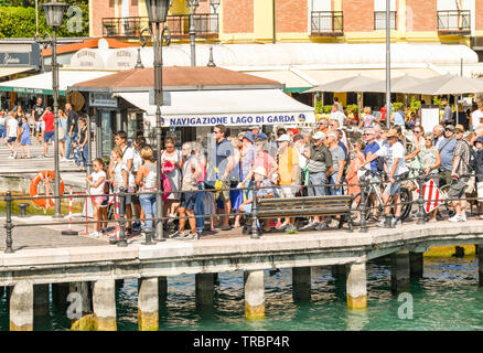 LAZISE, LAKE GARDA, ITALY - SEPTEMBER 2018:  People waiting to catch a ferry in Lazise on Lake Garda. Stock Photo