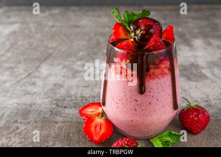 healthy delicious breakfast. strawberry chia seed pudding with chocolate, fresh berries and mint. close up Stock Photo