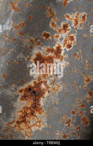 A damaged and rusty old corrugated steel abstract background Stock Photo