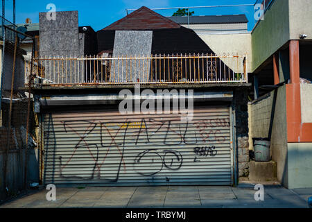 Graffiti on a metal garage door of the house. Stock Photo