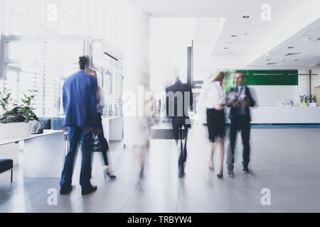 businesspeople walking in the corridor of an business center, pronounced motion blur Stock Photo