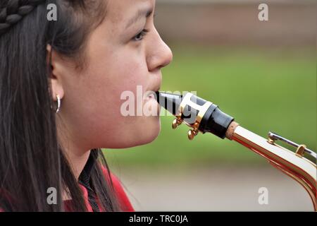 Hispanic kids who are members of California schools marching bands with instruments at Santa Maria parade Stock Photo