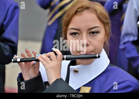 Hispanic kids who are members of California schools marching bands with instruments at Santa Maria parade Stock Photo