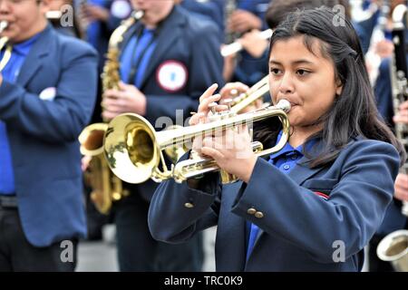 Hispanic kids who are members of California schools marching bands with instruments at Santa Maria parade Stock Photo