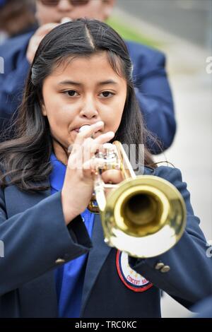 Hispanic kids who are members of California schools marching bands with instruments at Santa Maria parade Stock Photo