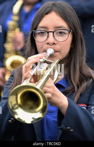 Hispanic kids who are members of California schools marching bands with instruments at Santa Maria parade Stock Photo