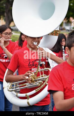 Hispanic kids who are members of California schools marching bands with instruments at Santa Maria parade Stock Photo