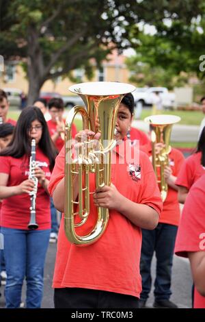 Hispanic kids who are members of California schools marching bands with instruments at Santa Maria parade Stock Photo