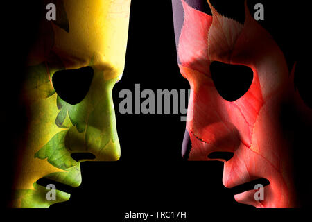 Autumn and summer face masks head to head on a black background Stock Photo