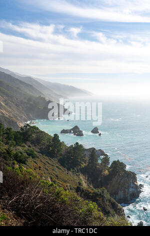 High overlook of the amazing Big Sur coastline along famous highway one during golden hour. Stock Photo