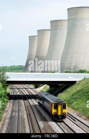 East Midlands class 156 diesel train passing Ratcliffe Power Station, Nottinghamshire, England, UK Stock Photo