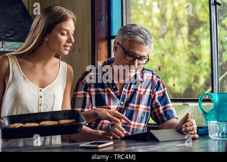 Father and daughter using digital tablet Stock Photo