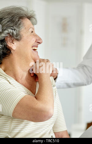 Doctor consoling senior woman Stock Photo