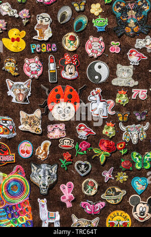 brown felt full of various pins of various figures Stock Photo