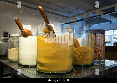 Manila, Philippines - August, 4, 2016: A shelf in a shop with colorful natural spices and powders in glass jars on display Stock Photo