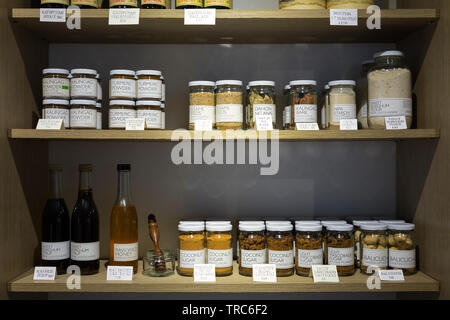 Manila, Philippines - August, 4, 2016: Wooden shelves in a shop full of jars and bottles with natural organic products Stock Photo