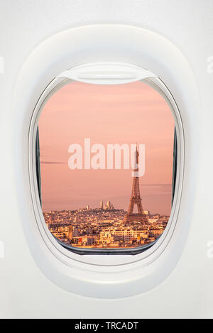 Paris at sunset seen through the window of airplane, travel in Europe concept Stock Photo