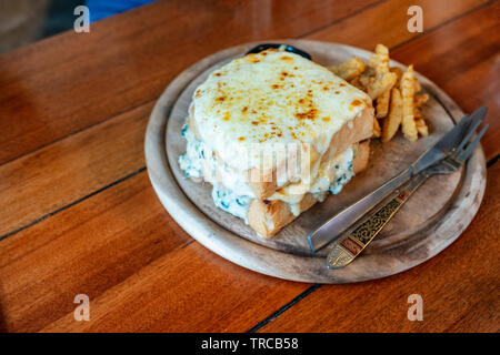 Baked bread spinach with cheese with french-fries on wooden tray Stock Photo