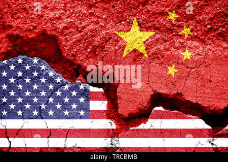 Flag of USA and China on a cracked background. Concept of crisis between two nations, Washington and Beijing
