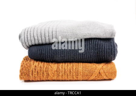 Sweaters in the stack on the white Stock Photo