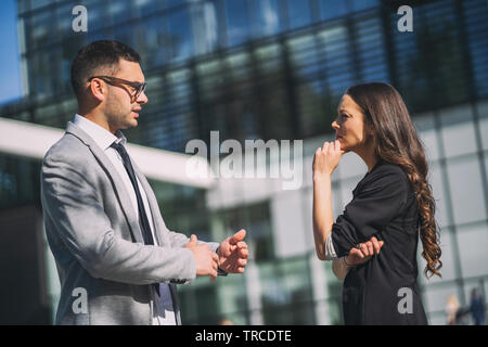 Business colleagues are talking outside the company building. Stock Photo