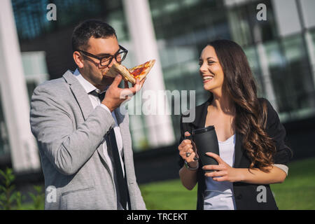 Business colleagues at lunch break standing in front the company building. Stock Photo