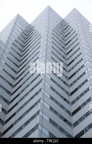 Angled protrusions of tall buildings of glass and concrete financial and business center of the modern city Stock Photo