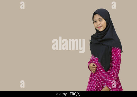 portrait of a beautiful Muslim hijab woman and smiling by posing in front of the camera. Isolated from a white background Stock Photo