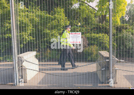 Warning notice on temporary fencing. Security around Winfield House, Regent's Park, London, UK for the State Visit of US President Donald Trump. Stock Photo
