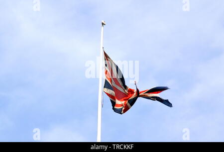 A torn Union Jack flag flies on the roof of Victoria train station, Manchester, UK. Stock Photo
