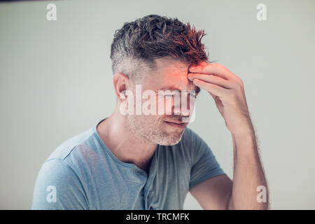 Handsome young man suffering from headache Stock Photo