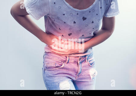 Stomach pain or menstrual pain. Woman with pains in abdomen. Female belly and hands close up. Stock Photo