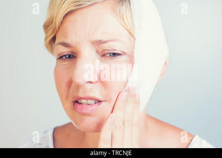 Closeup portrait of young woman achy girl suffering from terrible tooth pain Stock Photo