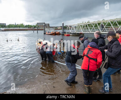 Glasgow, Scotland, UK. 3rd June, 2019. The Kelvin Kelpie is launched on The River Clyde at Kelvin Harbour. The new boat is a St Ayles skiff and was hand built by Glasgow Coastal Rowing Club at a workshop in the Riverside Museum. Credit: Skully/Alamy Live News