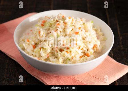 A Bowl of Coleslaw on a Distressed Wooden Table Stock Photo