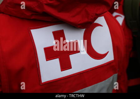 Details with the Red Cross and Red Crescent symbol on a uniform. Red Cross and the Red Crescent, are international humanitarian organizations Stock Photo