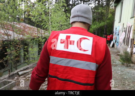 Details with the Red Cross and Red Crescent symbol on a uniform. Red Cross and the Red Crescent, are international humanitarian organizations Stock Photo