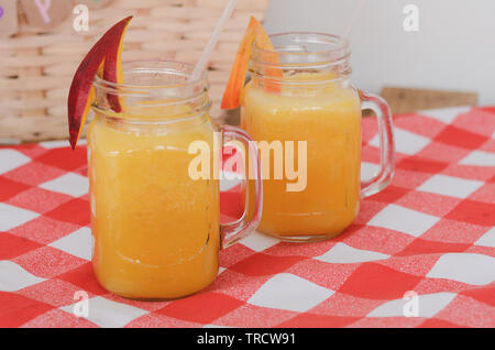 Jug of Mango and Orange Juice with Two Full Glasses Stock Photo - Alamy