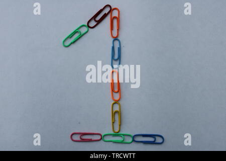 Number 1 made with colorful paper clips on white background Stock Photo
