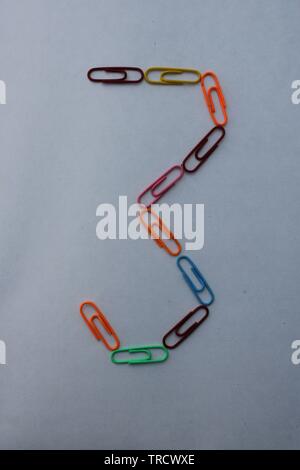 Number 3 made with colorful paper clips on white background Stock Photo