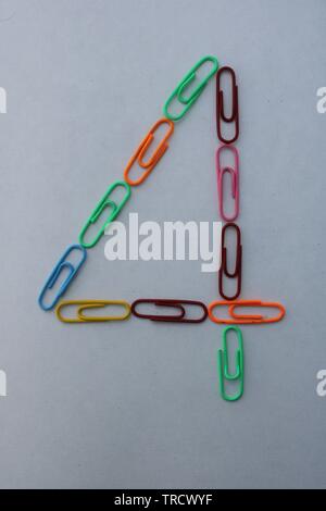 Number 4 made with colorful paper clips on white background Stock Photo