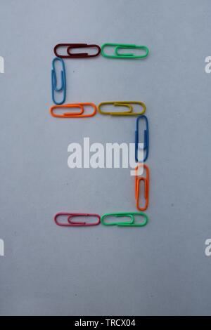 Number 5 made with colorful paper clips on white background Stock Photo